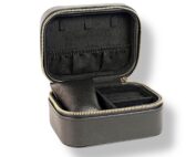Coffre à bijoux rectangle noir avec fermeture zippée dorée, compartiments pour bagues, boucles d’oreilles, bracelets et montres. Coffret élégant et compact pour organiser et protéger vos bijoux avec raffinement.